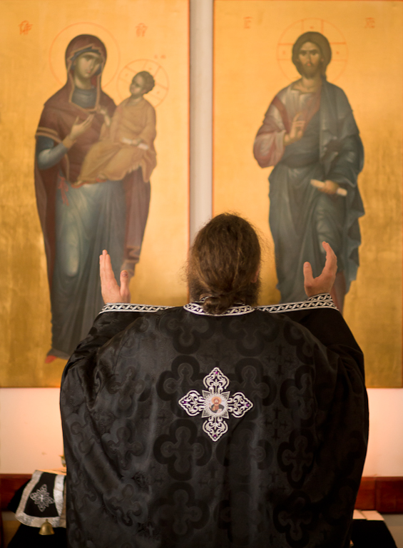 Father Iustin Petre prays during service.